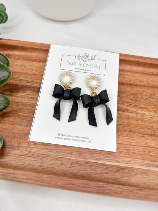 Black bows with pearl studs